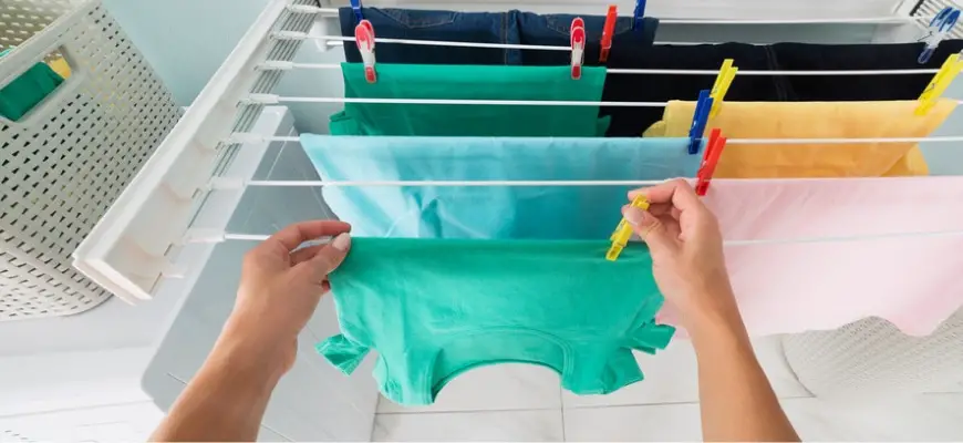 Person's hand hanging clothes