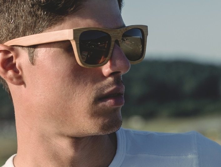 Model man portrait with wooden sunglasses outdoors