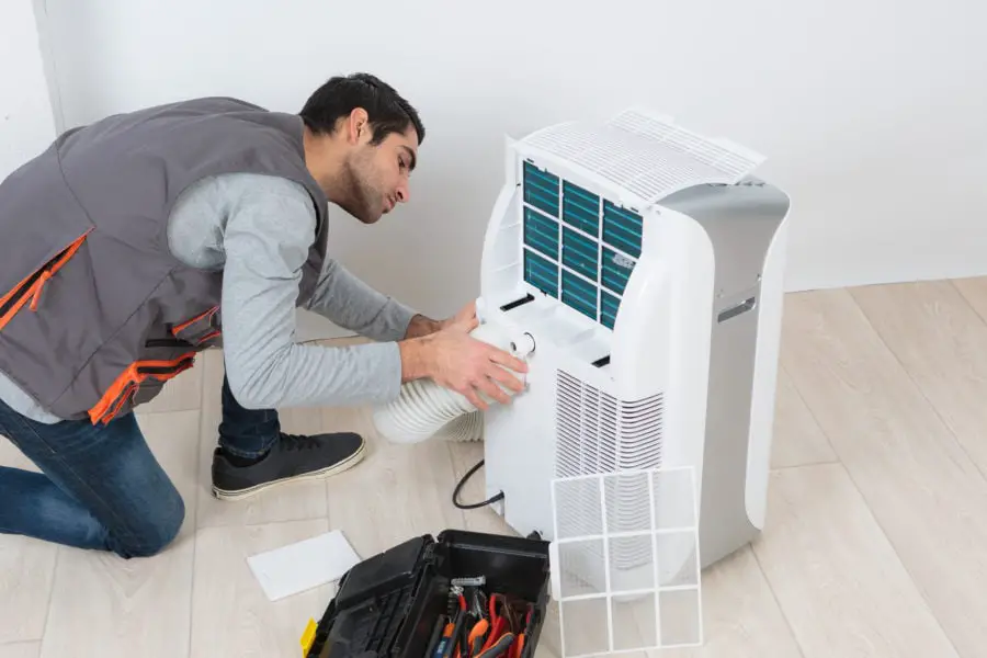 Man working on mobile air conditioning unit
