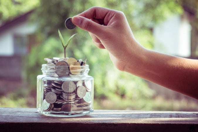 hand putting money coins