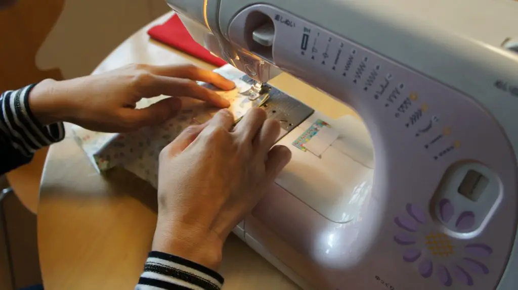 Woman's hand sewing using a sewing machine