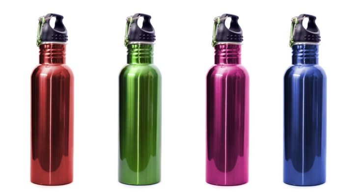 A set of four safe, reusable stainless steel water bottles isolated on white background in red, green, pink, and blue.