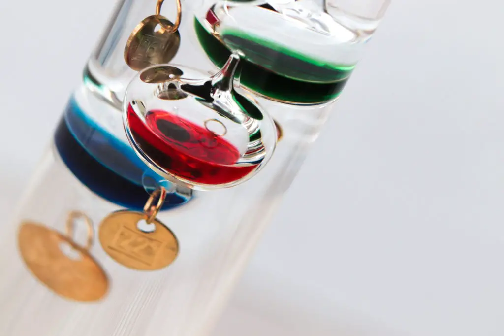 Detail of a galileo thermometer with white background
